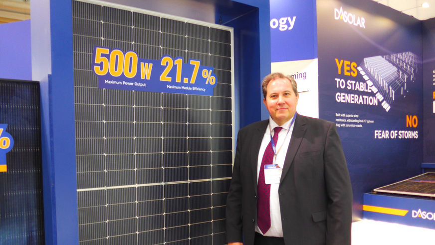 Alden Lee of DAS Solar next to the company's lightweight module, which can be supplied framed or frameless.