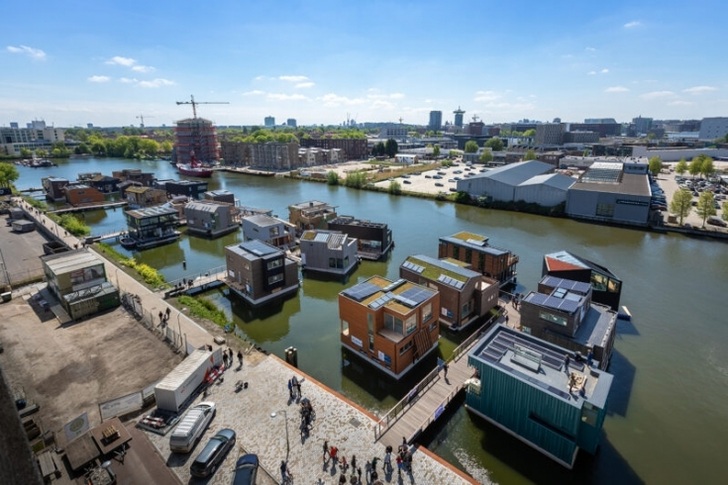These buildings in a floating solar housing estate on a canal in Amsterdam are connected to each other via a smart grid.
