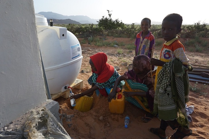Villagers with the solar-powered water desinlation system in Beyo Gulan, Somaliland. - © Phaesun
