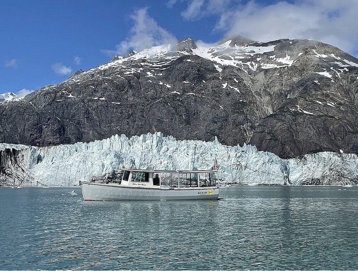 The solar powered Wayward Sun in front of a glacier in Alaska.