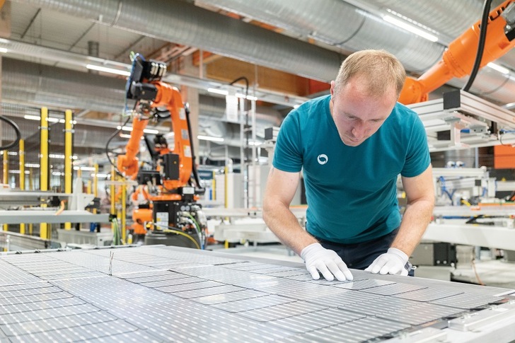 An employee checks the cells of a glass-glass module in Solarwatt's new production facility in Dresden/Germany.