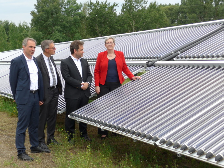 Carsten Körnig (BSW), Burkhard Exner (City of Potsdam), Moritz Ritter (Ritter Energie- und Umwelttechnik) and Federal Minister for Building Klara Geywitz (SDP) in front of the solar thermal ground-mounted system in Potsdam. - © H.C.Neidlein
