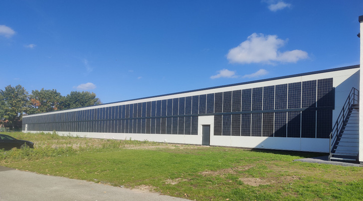 The solar installers have bonded the lightweight modules to the wall of the Group 24 building in two rows, one above the other.