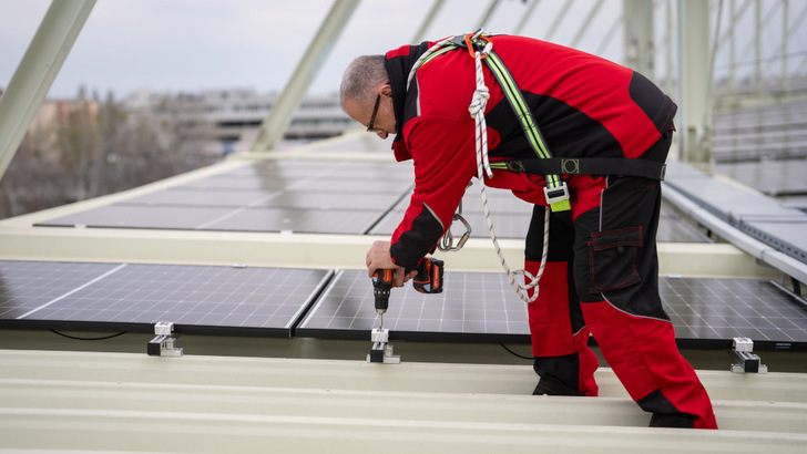 Getting down to it – a tricky but punctual installation on the stadium roof.