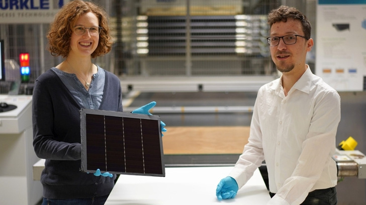 Project manager Dr Laura Stevens with Leonhard Böck, presenting one of the record-setting III-V germanium PV modules