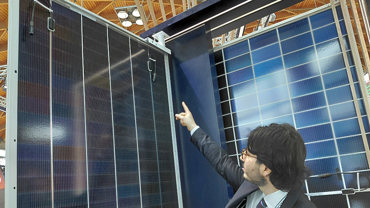 Gianluca Michieletto indicates the repositioned junction boxes on the back of the JA Solar Deep Blue module in Rimini