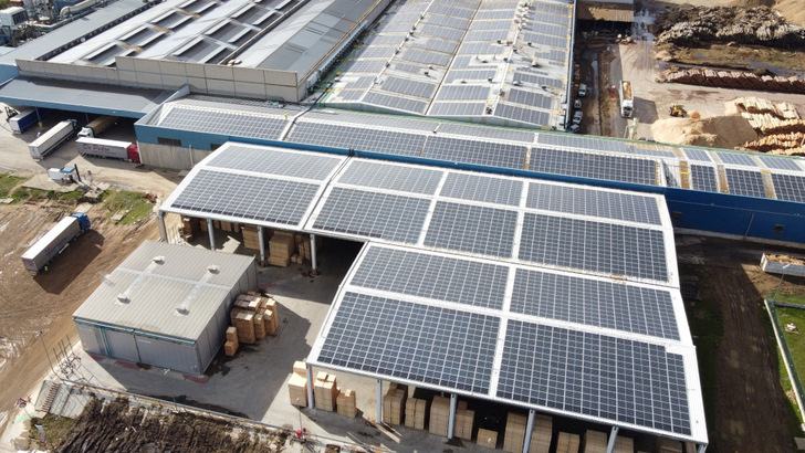 Working yard beneath a rooftop solar installation by IBC Solar in Spain