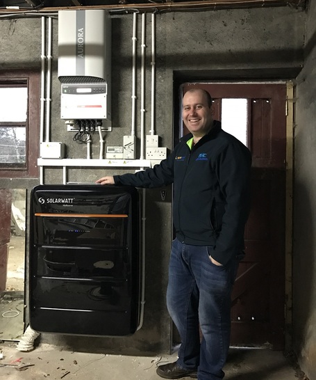 Pearse McHenry from BHC Distributors in Ballycastle with an installed MyReserve battery energy storage system. - © BHC Distributors
