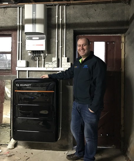 Pearse McHenry from BHC Distributors in Ballycastle with an installed MyReserve battery energy storage system.