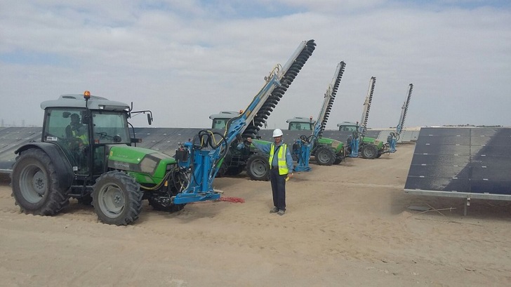 Four Sunbrush systems are mounted on tractors to clean the solar panels of a 200 MW solar park in Seih Al-Dahal, 60 kilometers outside from Dubai main city. - © Sunbrush mobil GmbH
