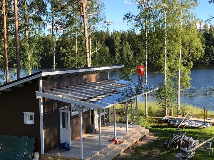 Mikko Jokinen, Category Manager, Commerce, at Onninen, tests the strength of Solarwatt panels on a new veranda with his more than 100kg frame. 