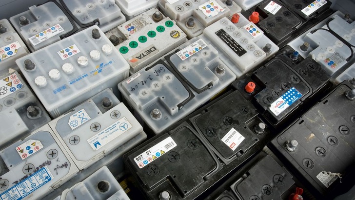 Old batteries in a container for transport.