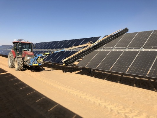 A SunBrush mobil Compact removes sand from solar modules at the Benban solar park.