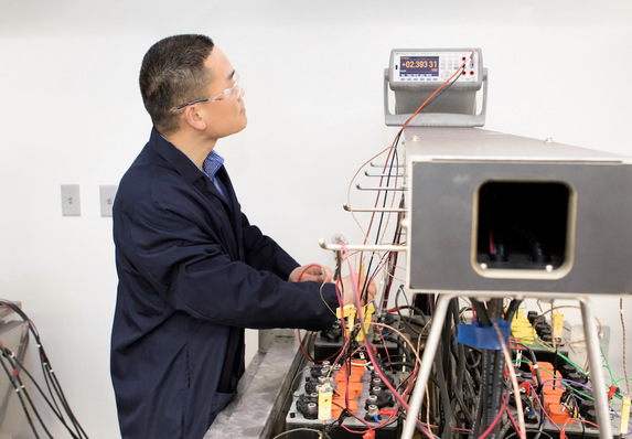 Enqin Gao, Chief Engineer of R&D, observes the voltages of battery cells during the PSoC Cycling test in Hammond Group’s state-of-the-art lead battery lab.