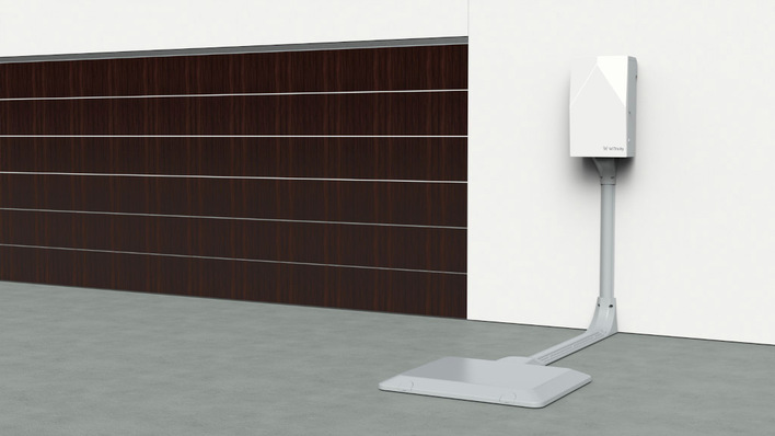 The charging station is laid in the ground and the car can then charge inductively when it is standing over it.