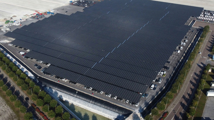 A sea of solar on top, hundreds of cars underneath.