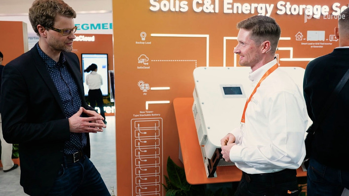 René Gelfert (right) discusses safety and the new functions of their commercial inverters.