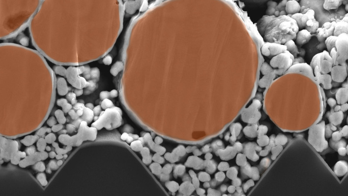 A colourised scanning electron microscope image of a contact printed with silver-coated copper paste, developed at Fraunhofer ISE.
