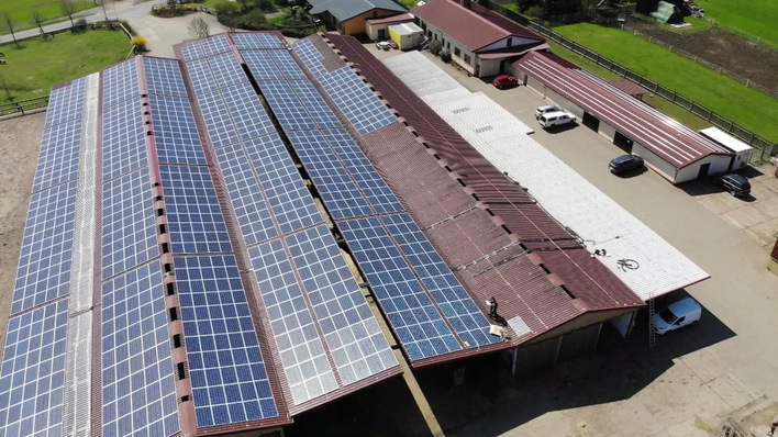 The renovated barn roofs at Thürengeti farm now carry solar panels, financed through lease payments.