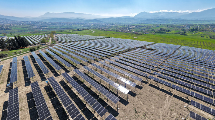 The elevated trackers create optimal growing conditions for the crops below