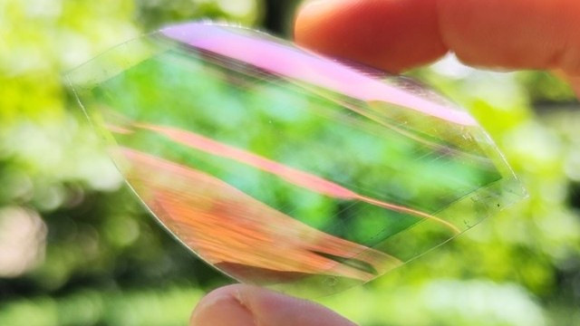 The iridescence comes from the layered electrodes, not from any added colour or coating