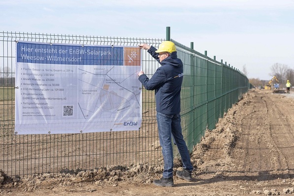 EnBW employee Michael Matthes attaches the construction sign on site.