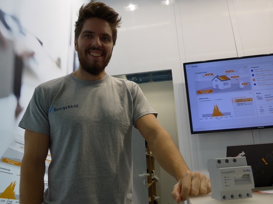 Dominik Gluba from EnBW with the Energy Base energy management system (the compact box at the right) at World of Energy Solutions in Stuttgart.