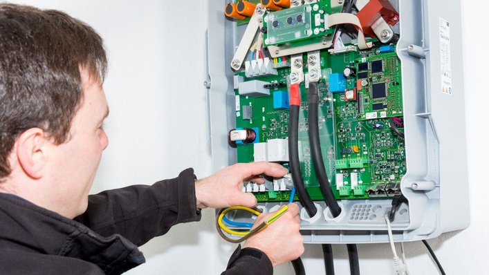 Connecting the 3-phase AC wires for the battery inverter.