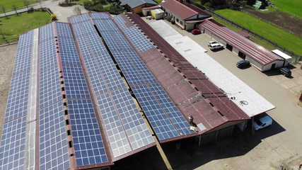 The renovated barn roofs at Thürengeti farm now carry solar panels, financed through lease payments.