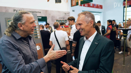 Ludwig Schletter (right) talks about bigger projects and bigger solar roofs